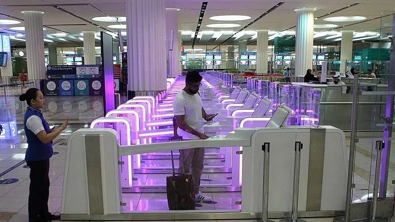 A passenger passing through the Smart Gates at Dubai International Airport